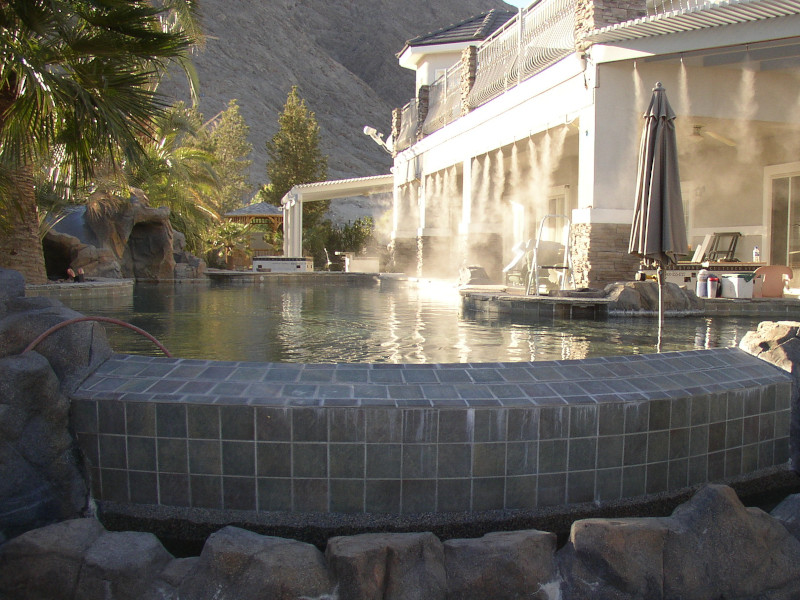 backyard patio with misting system and pool