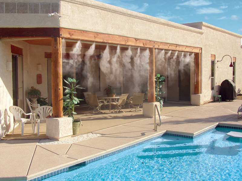 backyard patio with misting system and pool